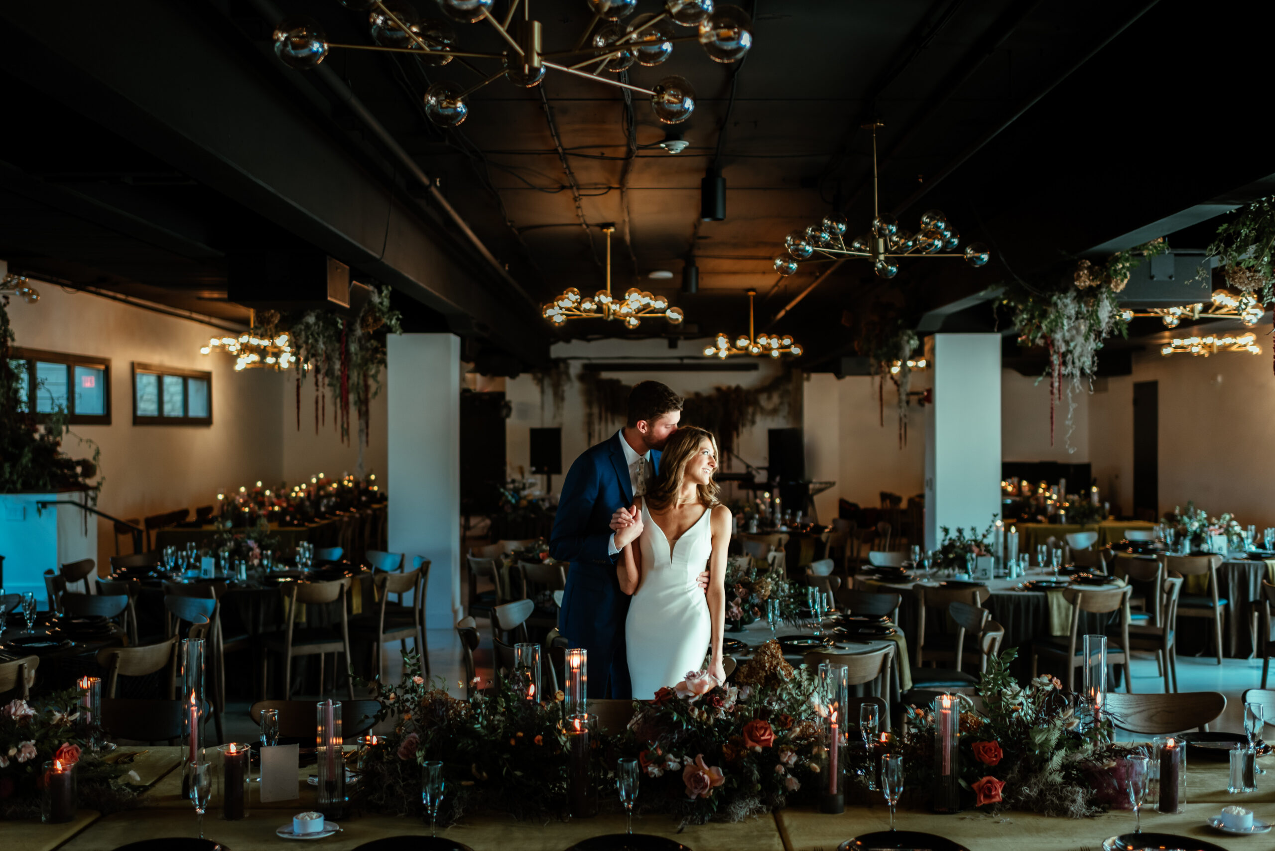 Couple Standing in The Cove at Watersedge with Florals Designed by Fiori Florals