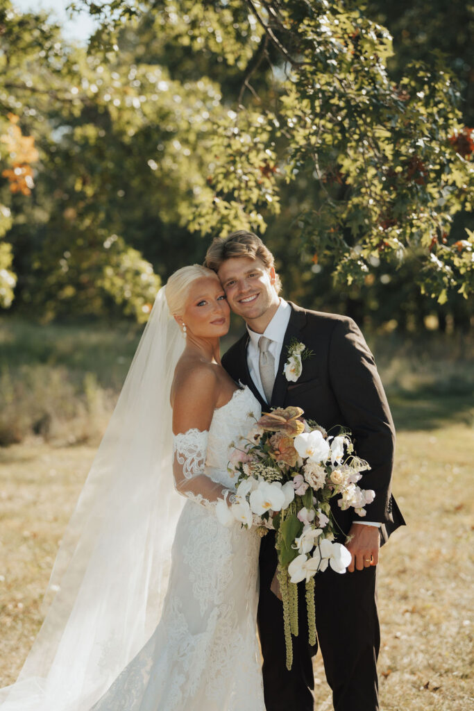 Photograph by Pictures by Ash, Bride holding bouquet and groom has boutonniere on lapel both designed by Columbus Wedding Florist Fiori Florals Design Studio